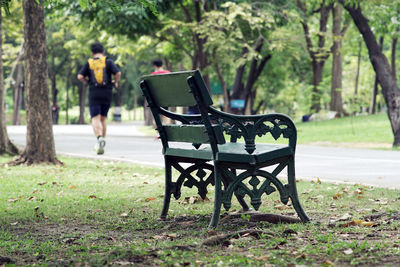 Crowd of people exercising, running and riding bicycle in the park on a beautiful sunday morning