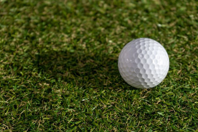 High angle view of golf ball on grassy field