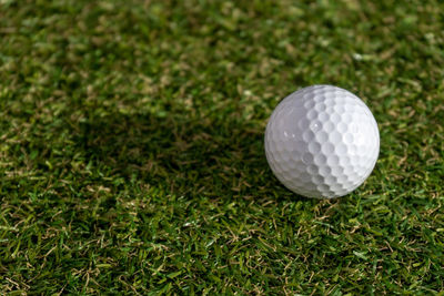 High angle view of golf ball on grassy field
