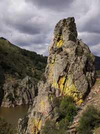 Rock formation on mountain against sky