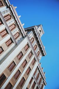 Low angle view of building against clear blue sky