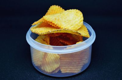 High angle view of yellow slices in bowl on table