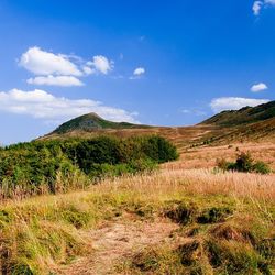 Scenic view of landscape against cloudy sky