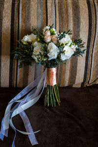 Close-up of wedding bouquet on sofa at home 