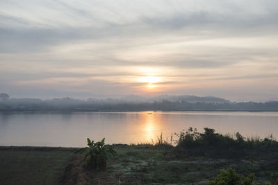 Scenic view of lake against sky during sunset