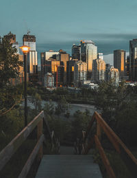 Modern buildings in city against sky at dusk