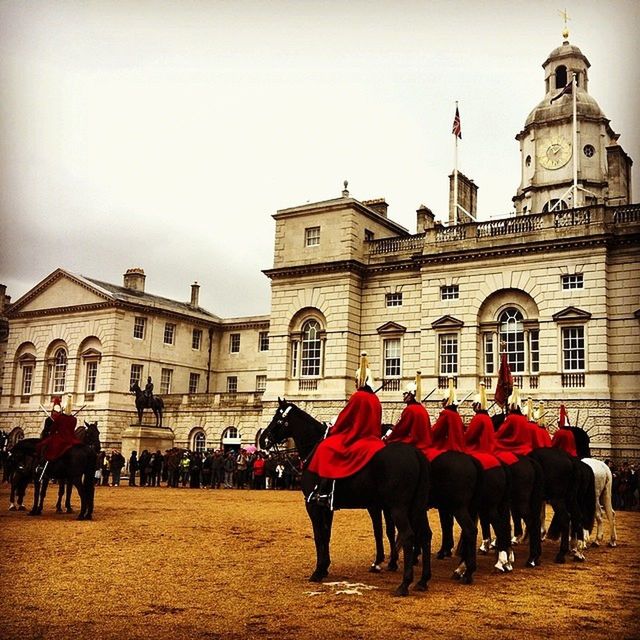 architecture, building exterior, built structure, large group of people, person, men, animal themes, sky, domestic animals, walking, horse, travel destinations, lifestyles, tourism, facade, religion, clear sky, history, red