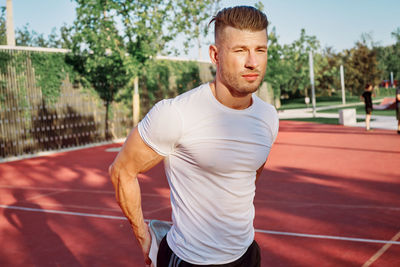 Portrait of young man exercising in gym