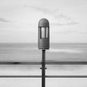 Lighting equipment at beach against sky