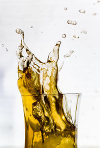 Close-up of drink glass against white background