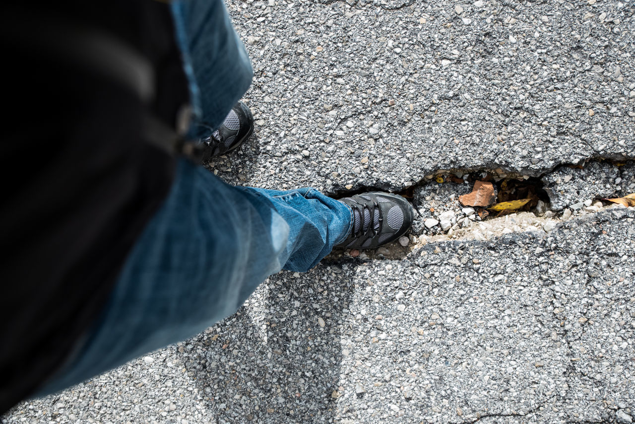 LOW SECTION OF MAN STANDING ON STREET