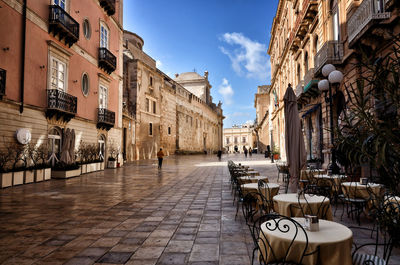 Street amidst buildings in city against sky