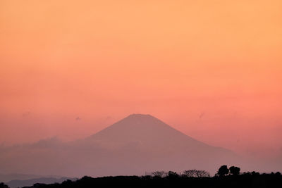 Scenic view of silhouette mountains against sky during sunset