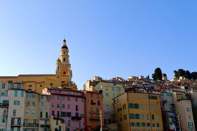 Low angle view of buildings against blue sky