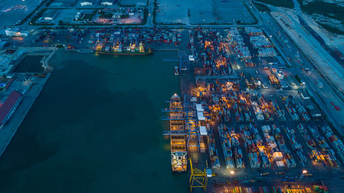 High angle view of illuminated container ship at commercial dock