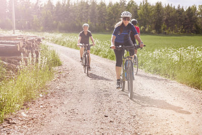 Cyclists cycling along dirt track