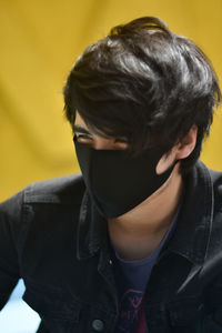 Close-up portrait of boy against wall