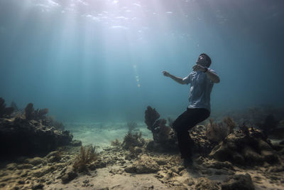 Man on shore against sea