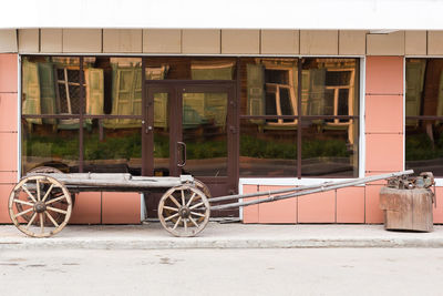 An old cart is displayed on a pedestrian street as a decoration for tourists.