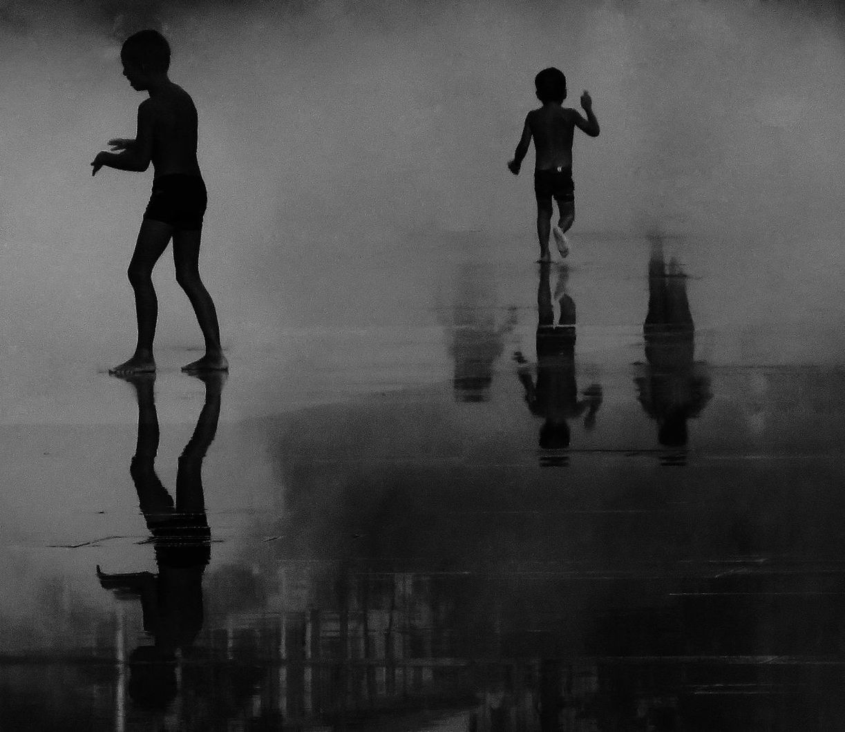 SILHOUETTE OF BOY RUNNING ON BEACH