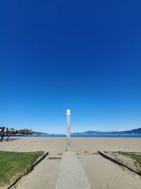 Scenic view of beach against clear blue sky