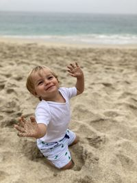 Full length of cute baby boy on beach
