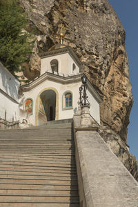 Low angle view of staircase and building against mountain