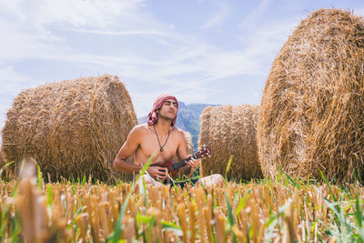 Young woman sitting on field