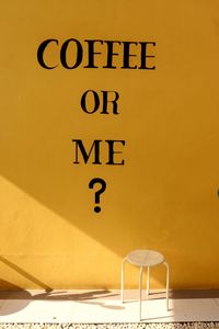 Close-up of text on yellow wall