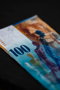 Close-up of colored pencils on table against black background