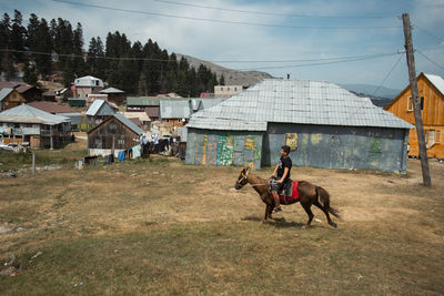 A young boy rides a horse.  adjara region of  georgia