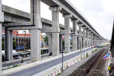 Railroad tracks in city against sky