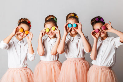 Boy and girl wearing mask against white background