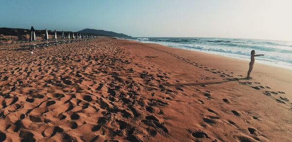 Scenic view of beach against clear sky