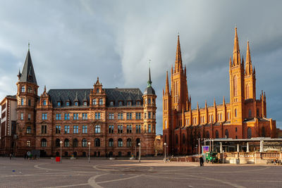 View of buildings against cloudy sky