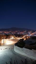 High angle view of illuminated city buildings at night