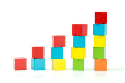 Stack of multi colored toy against white background