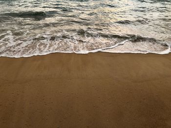 High angle view of waves rushing towards shore