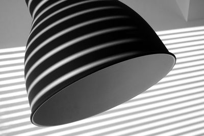 Close-up of electric lamp on table against wall