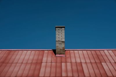 Low angle view of modern building against blue sky