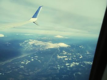 Aerial view of airplane wing over landscape