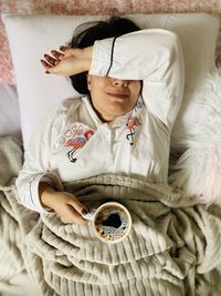 High angle view of girl sleeping on bed at home