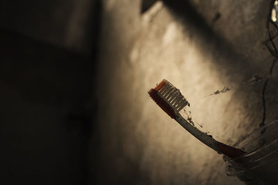 Low angle view of telephone pole against wall