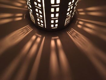 Close-up of illuminated lamp on table