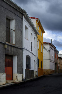 Low angle view of buildings in a village against sky