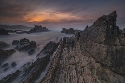 Panoramic view of rocks against sky during sunset