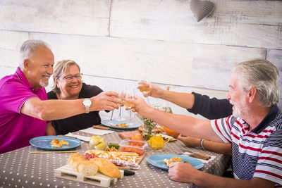 Senior friends sitting at dining table during breakfast