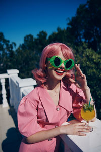 Young woman drinking juice outdoors