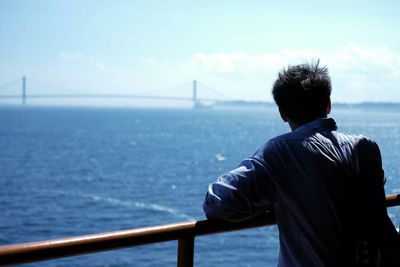 Rear view of man looking at sea