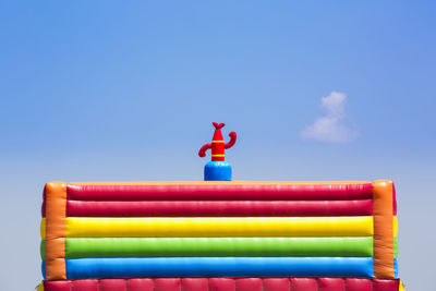 Low angle view of colorful inflatable balloon against sky